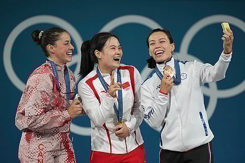 Paris Olympics women's 59kg weightlifting: Maude Charron of Canada, silver, Luo Shifang of China, gold, and Kuo Hsing-Chun of Taiwan, bronze